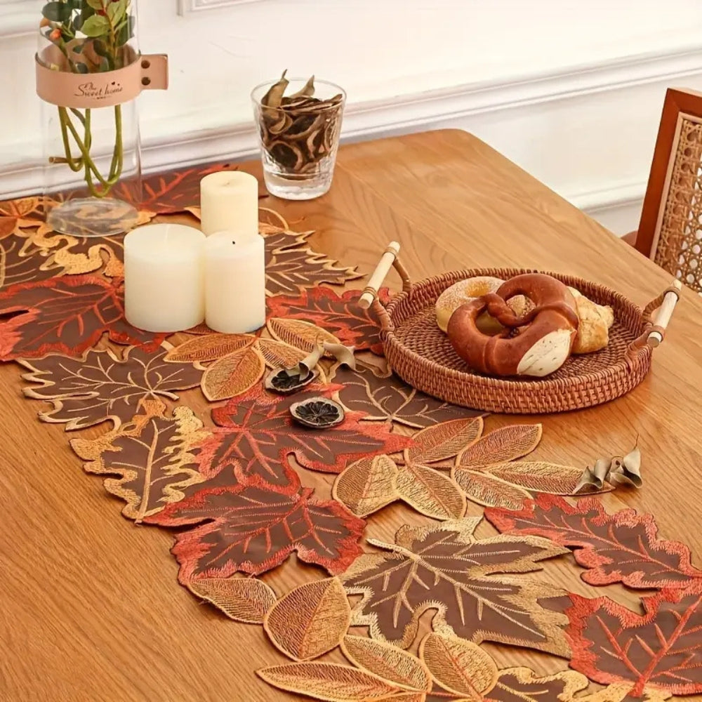 Embroidered autumn maple leaf runner styled on a dining table; selected size may differ