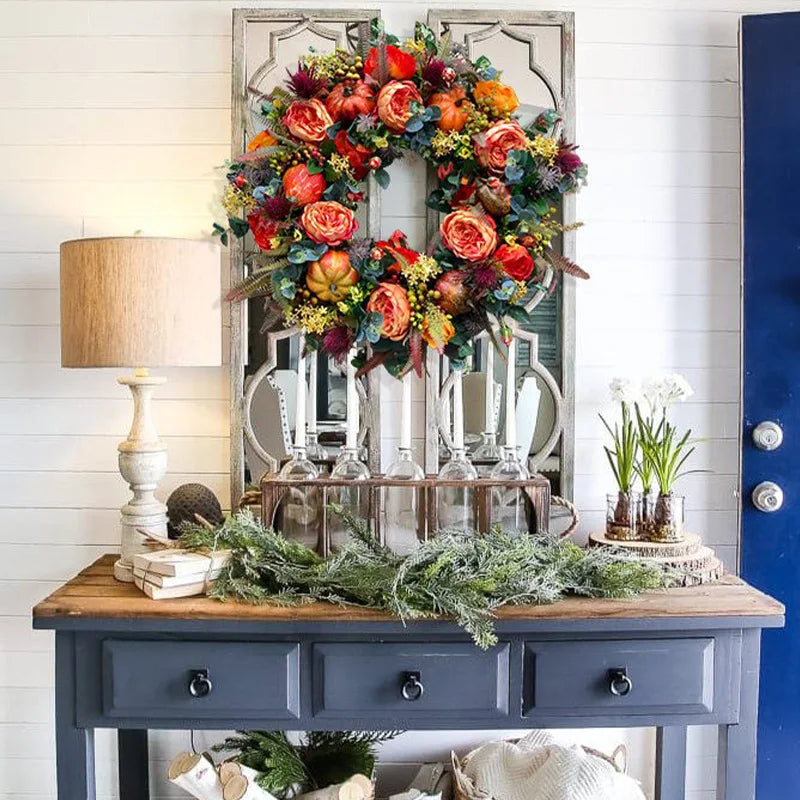 Artificial autumn wreath in a styled entryway display