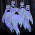 White LED hanging ghost Halloween decorations glowing at night