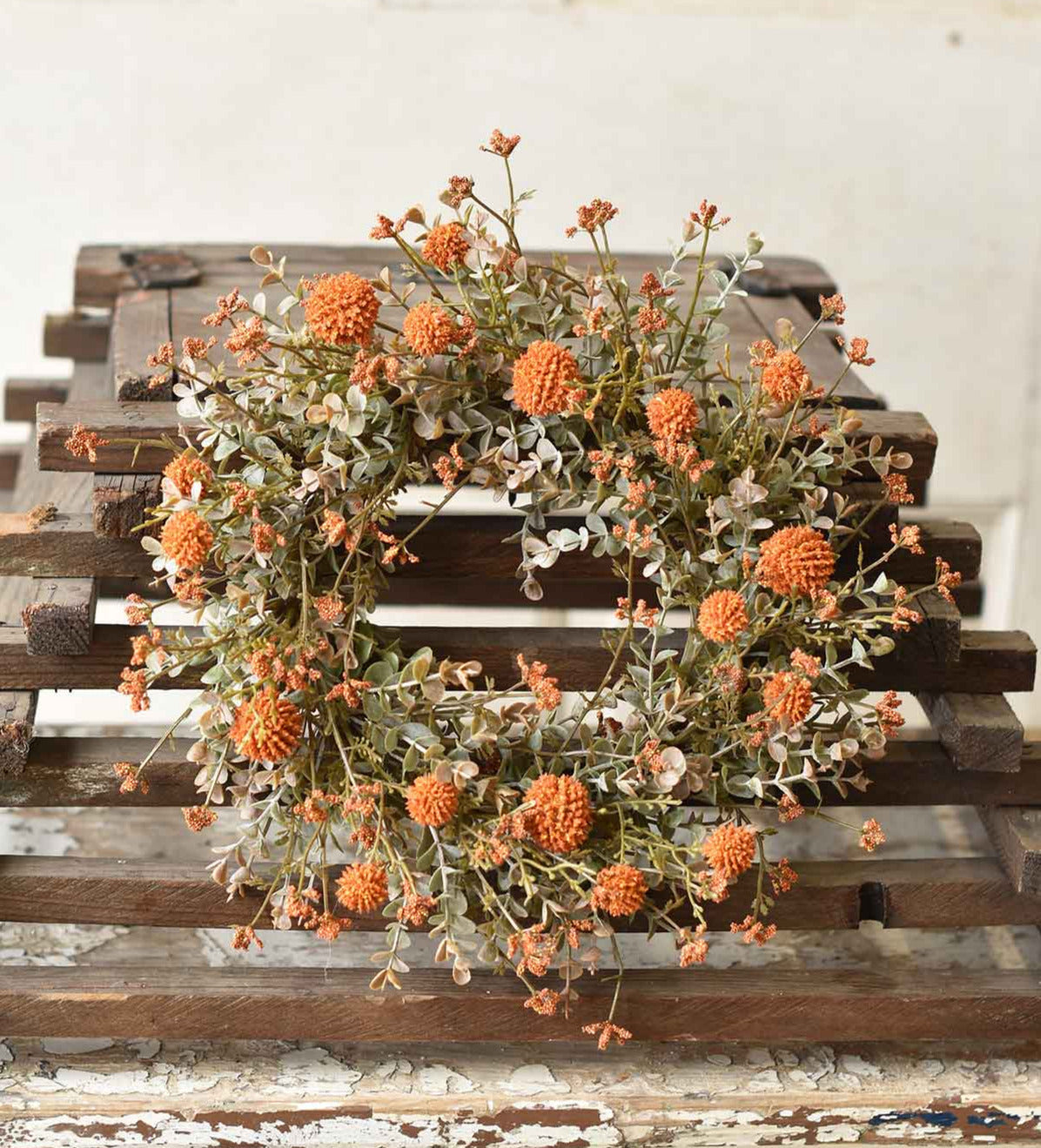 Orange faux flower candle ring shown from above