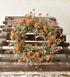 Orange faux flower candle ring shown from above