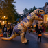 Inflatable T-Rex dinosaur costume trick-or-treating at dusk